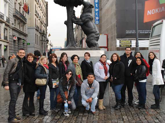 Group of students in front of a bear statue